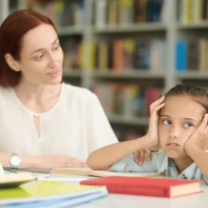 Adverse childhood experiences course learner reading with a young child